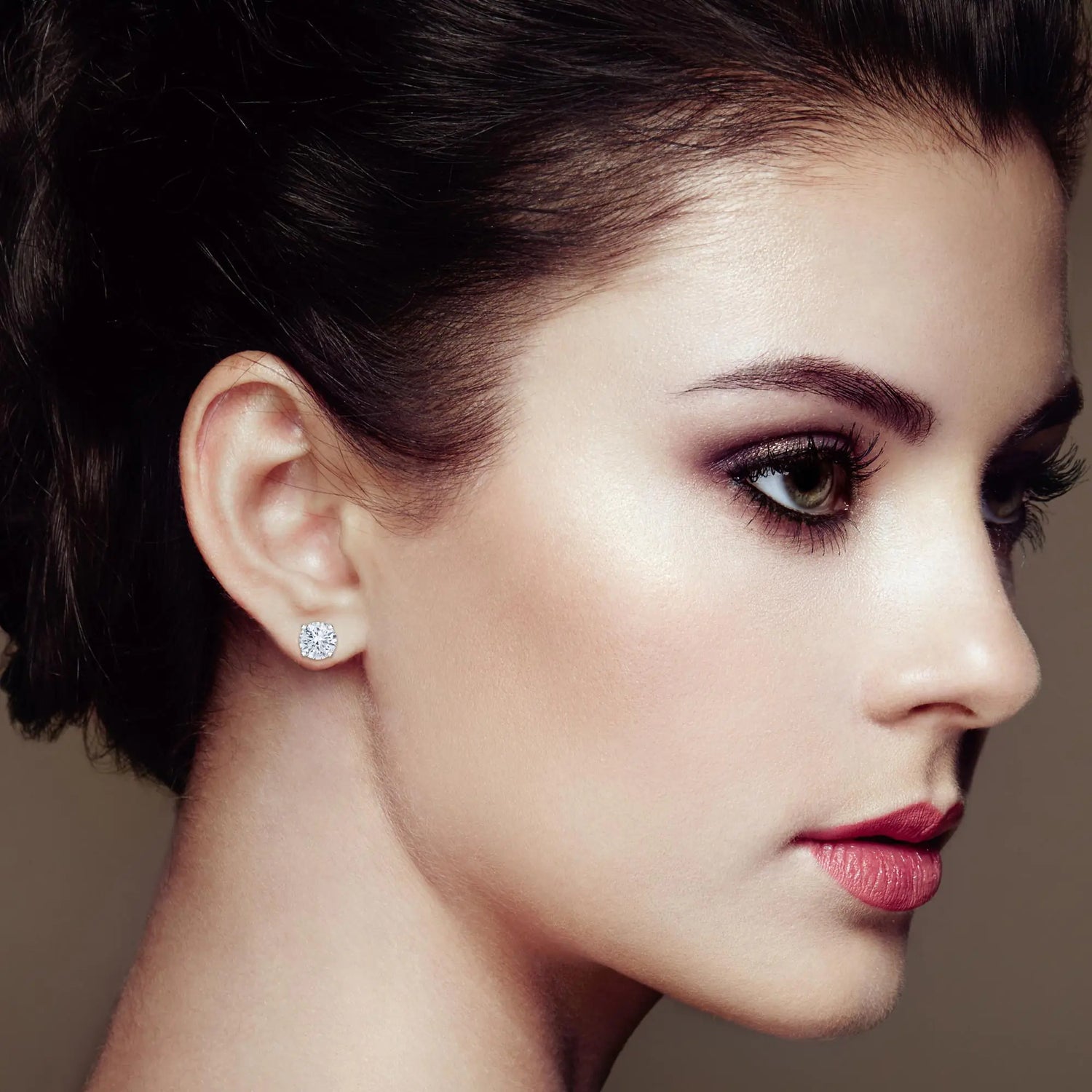 Side profile of a woman wearing diamond earrings